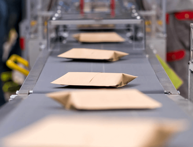 mailer packages traveling on conveyor belt